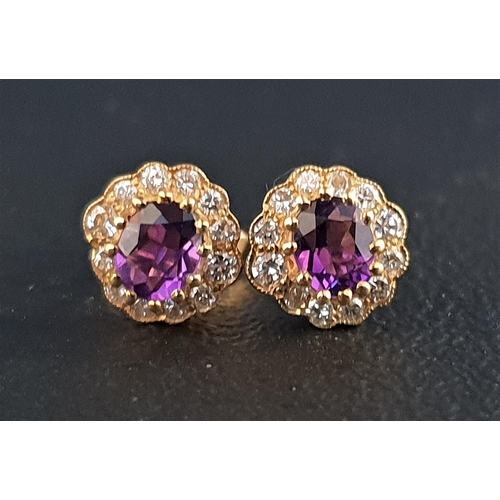 27 - PAIR OF AMETHYST AND DIAMOND CLUSTER EARRINGS
each stud earring with central oval cut amethyst of ap... 