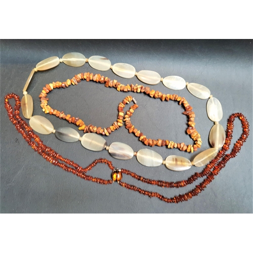 39 - TWO AMBER BEAD NECKLACES
one natural amber and the other a double strand polished amber necklace, to... 