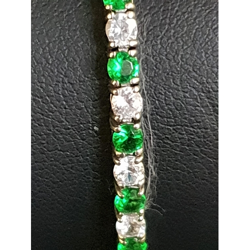 74 - GREEN AND WHITE CZ SET LINE BRACELET
in silver, approximately 18cm long
