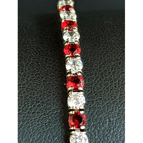 95 - RED AND WHITE CZ SET LINE BRACELET
in silver, approximately 18cm long