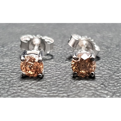 105 - PAIR OF CHAM[AGNE DIAMOND STUD EARRINGS
the diamond totalling approximately 0.5cts, in nine carat wh... 