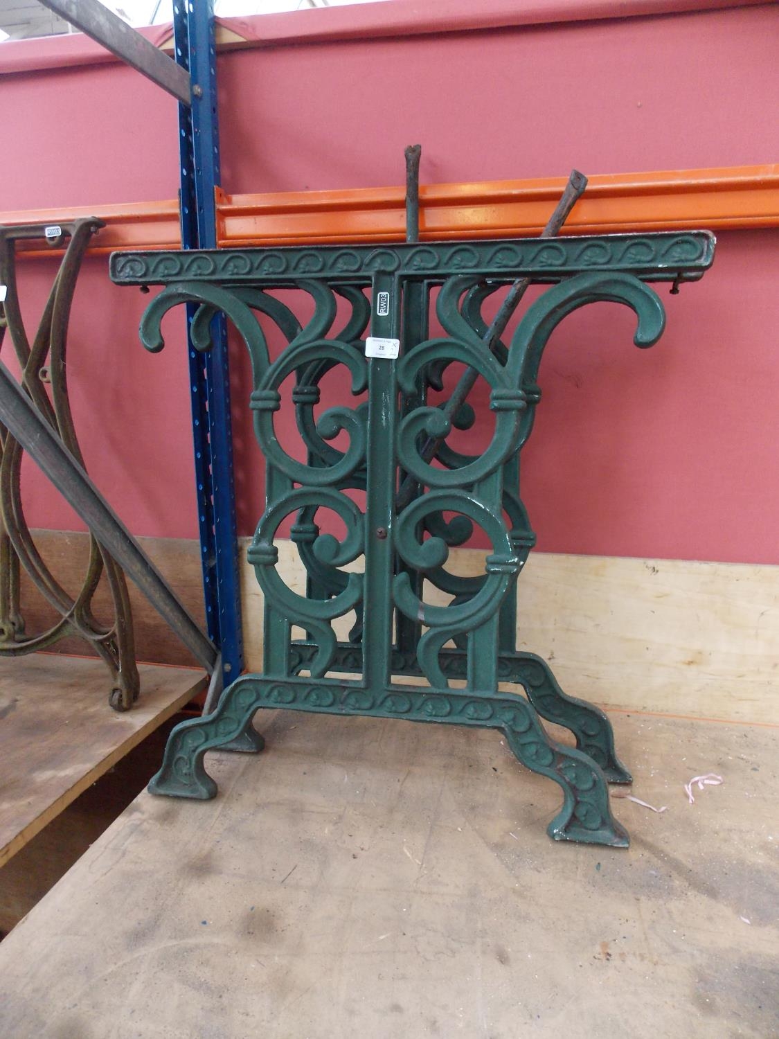 A PAIR OF GREEN PAINTED CAST IRON ORNATE GARDEN TABLE LEGS