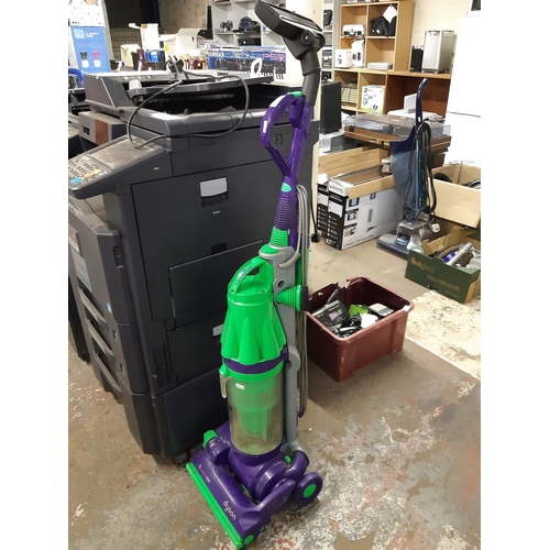 A purple and green Dyson DC07 upright 