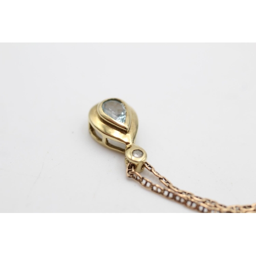 32 - A 9ct gold topaz and diamond teardrop pendant necklace - approx. gross weight 4.2 grams