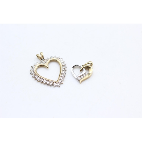 10 - Two 9ct yellow and white gold diamond set heart pendants - approx. gross weight 3.2 grams