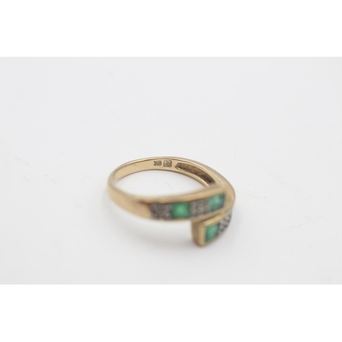 28 - A 9ct gold emerald and diamond channel setting overlap ring, size M½ - approx. gross weight 2.3 gram... 