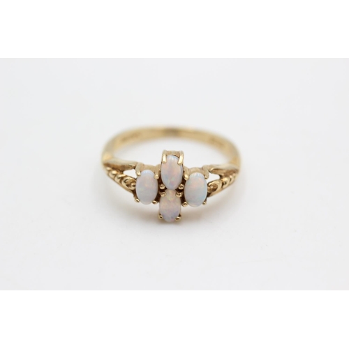 33 - A hallmarked London 9ct gold opal four stone dress ring, size O½ - approx. gross weight 2.9 grams