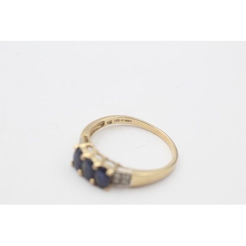 42 - A hallmarked Birmingham 14ct gold sapphire and diamond trilogy and pave setting dress ring, size V½ ... 