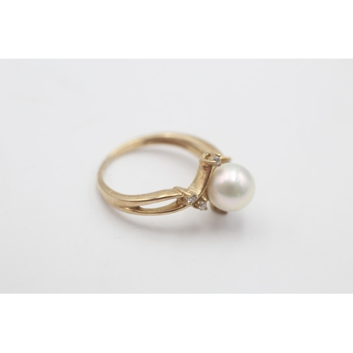57 - A 9ct gold pearl and diamond seven stone floral crossover setting ring, size K½ - approx. gross weig... 