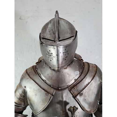 A Medieval style 6ft fully enclosed suit of armour with sword and stand ...