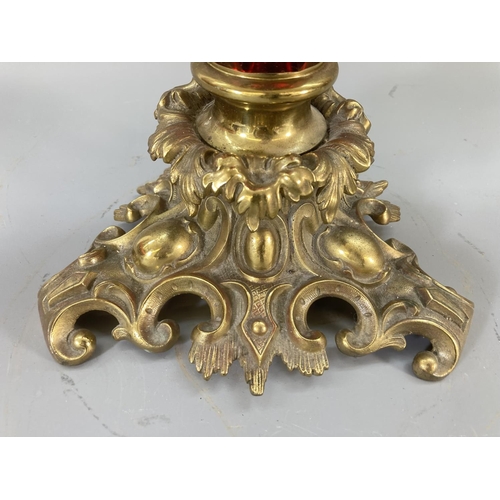 114 - A late 19th/early 20th century Duplex brass and cranberry glass oil lamp - approx. 62cm high
