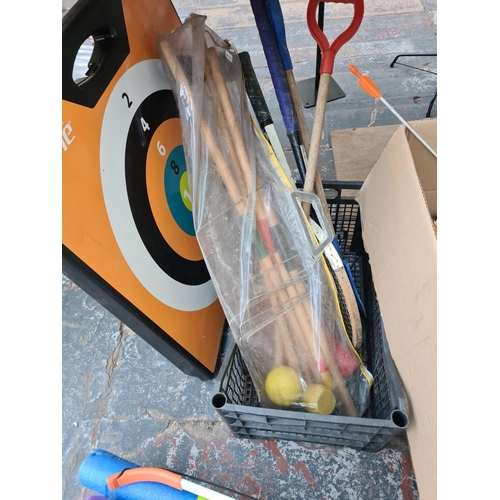 Three boxes containing various sports equipment to include footballs