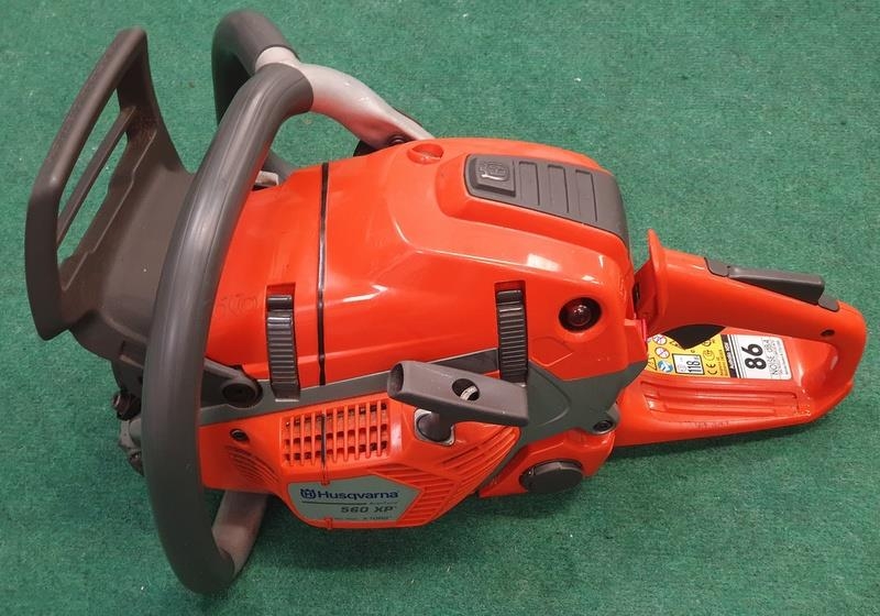 A Husqvarna 560 XP Chainsaw (REF 23).