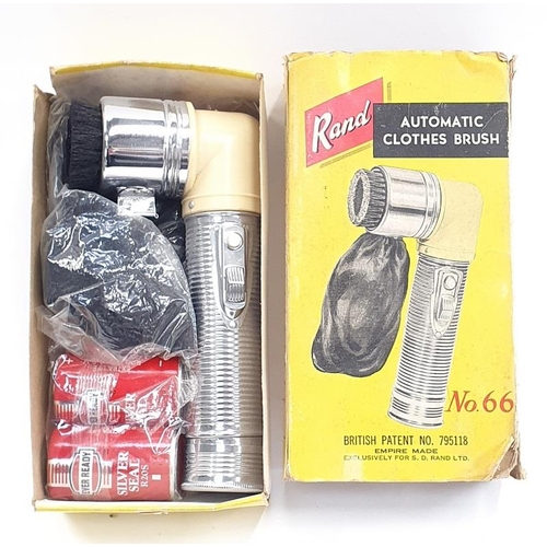84 - A 1950s Bakelite hand-held battery operated clothes brush boxed.