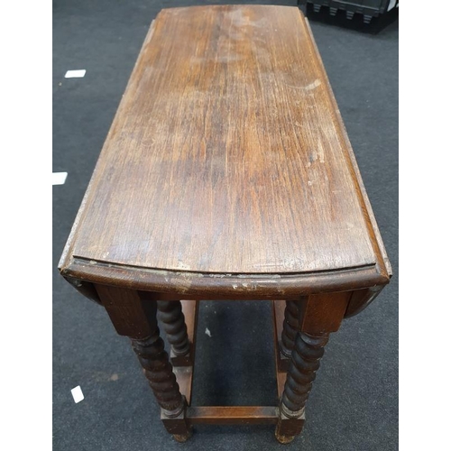 1466 - A vintage oak gate leg table with barley twist supports.