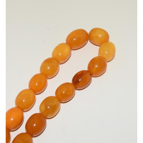 206 - A Strand of Vintage Baltic Butterscotch Yellow Amber Beads. Weight 72g. Beads 15mm - 22mm.