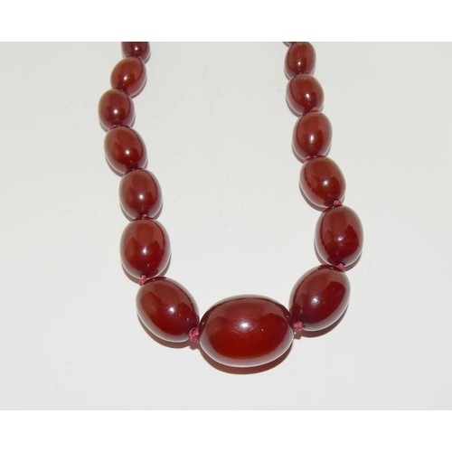 127 - A Strand of Cherry Art Deco Bakelite Amber Beads Marbled with Swirls. 63g