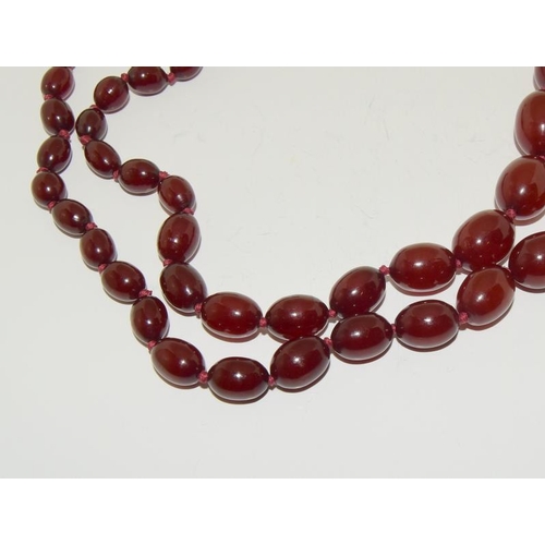 127 - A Strand of Cherry Art Deco Bakelite Amber Beads Marbled with Swirls. 63g