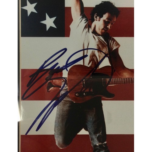 344 - BRUCE SPRINGSTEEN SIGNED AUTOGRAPH. A superb signature from THE BOSS on colour photo surrounded by v... 