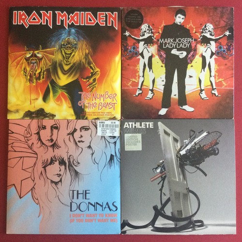 28 - 4 X 7” VINYL SINGLES. Lot to include a collector's limited edition Iron Maiden red coloured vinyl of... 