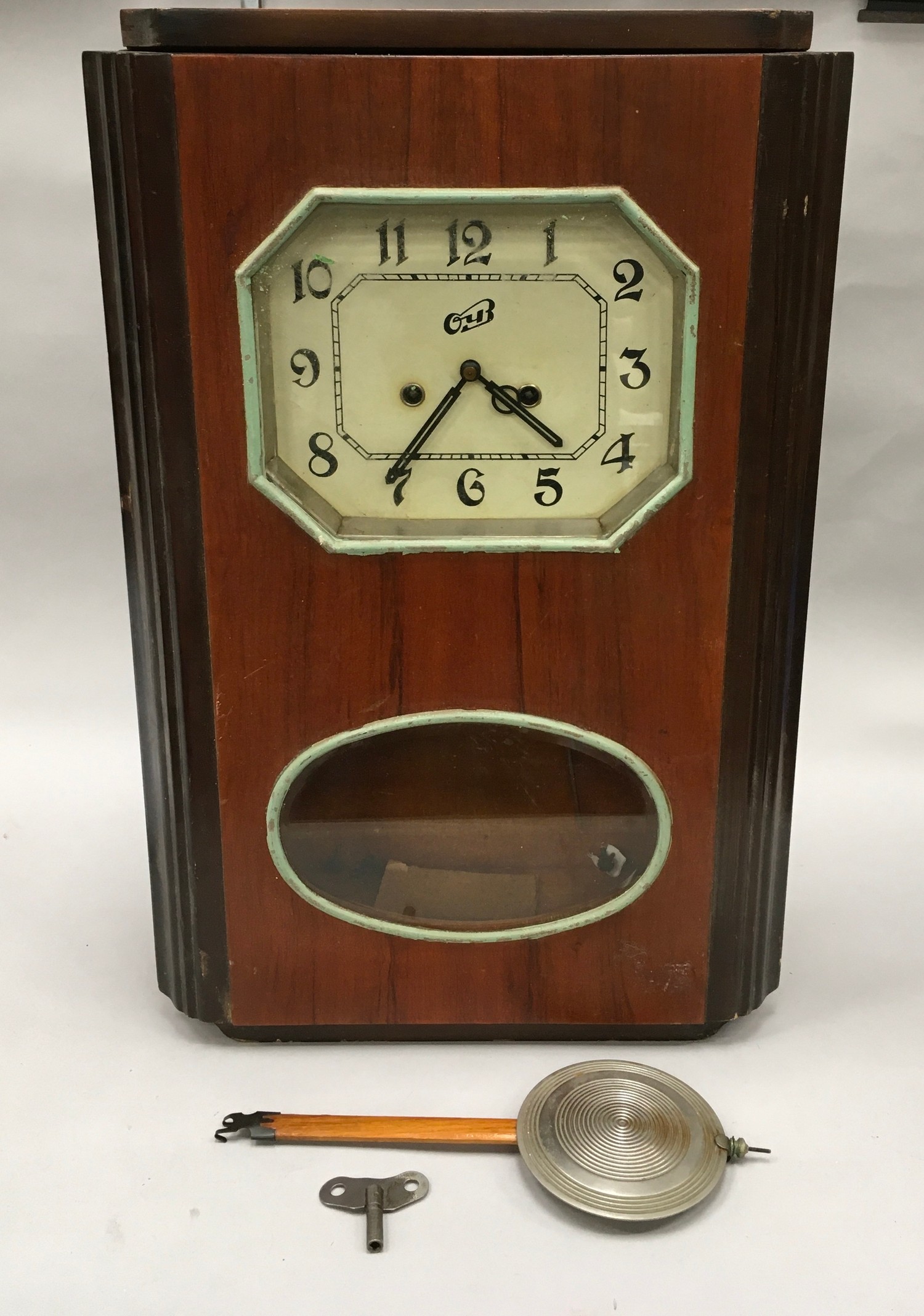 Wood Surround Striking Wall Clock With Key And Pendulum