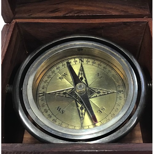 29 - Compass in decorative wooden case.