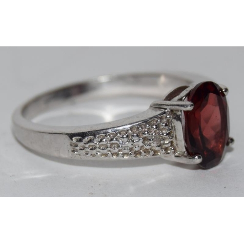 67 - A silver 925 ring with garnet stone size Q