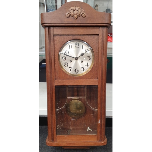 Oak cased wall hanging striking clock with key and pendulum | Barnebys