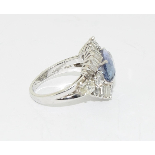 128 - Substantial platinum ring with central sapphire of approx 5.6ct surrounded by diamonds size O