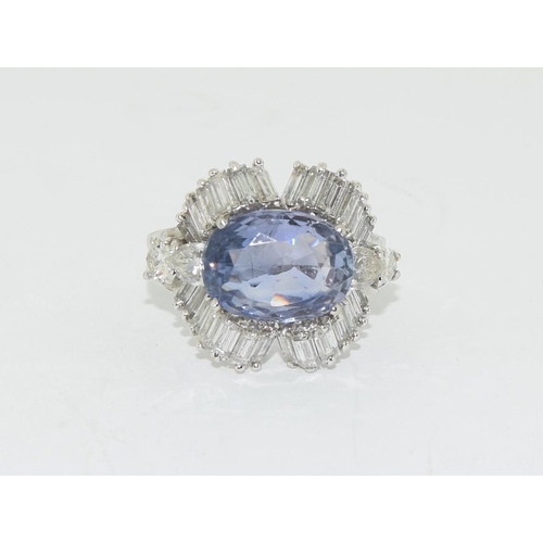 128 - Substantial platinum ring with central sapphire of approx 5.6ct surrounded by diamonds size O
