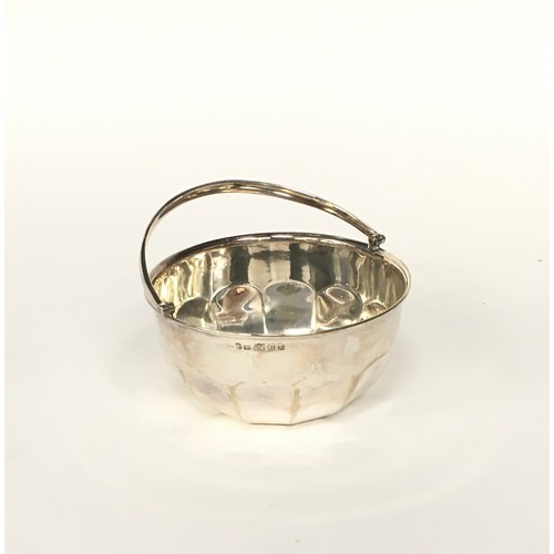 25 - Silver with swing handled bowl, silver 3 leg pill pot, together a silver small embossed bowl