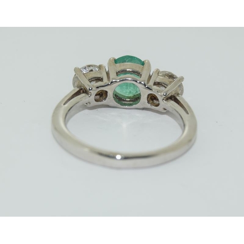 1091 - An 18ct white gold emerald and diamond three stone ring of approx  2cts.Size K