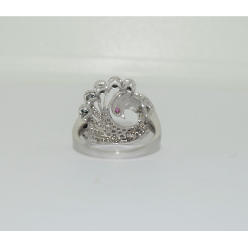 1077 - 14ct white gold ladies ring in the shape of a dove set with blue and white diamonds size P