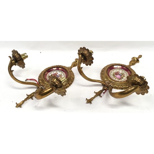 209 - A pair of decorative brass wall sconces with Meissen Limoges pictoral plaques together with a three ... 