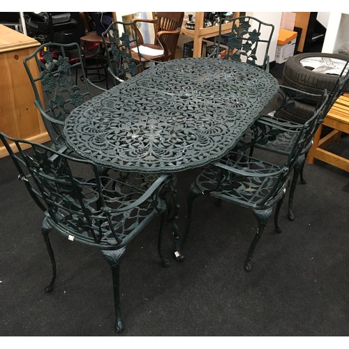 Cast metal garden table and 6 chairs the oval table with und... Barnebys