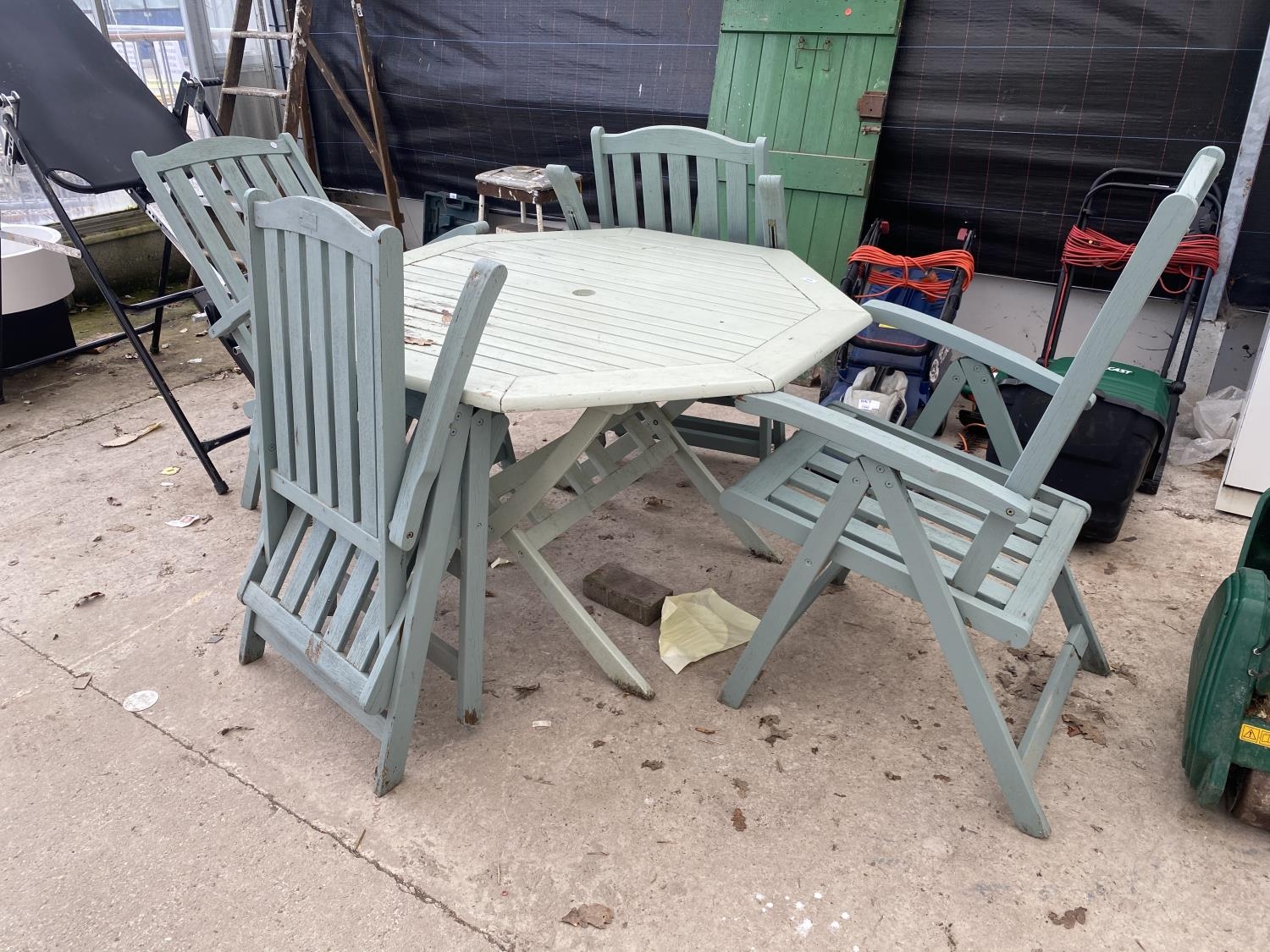 A HEAVY WOODEN GARDEN PATIO SET TO INCLUDE TABLE AND FOUR PAINTED TEAK