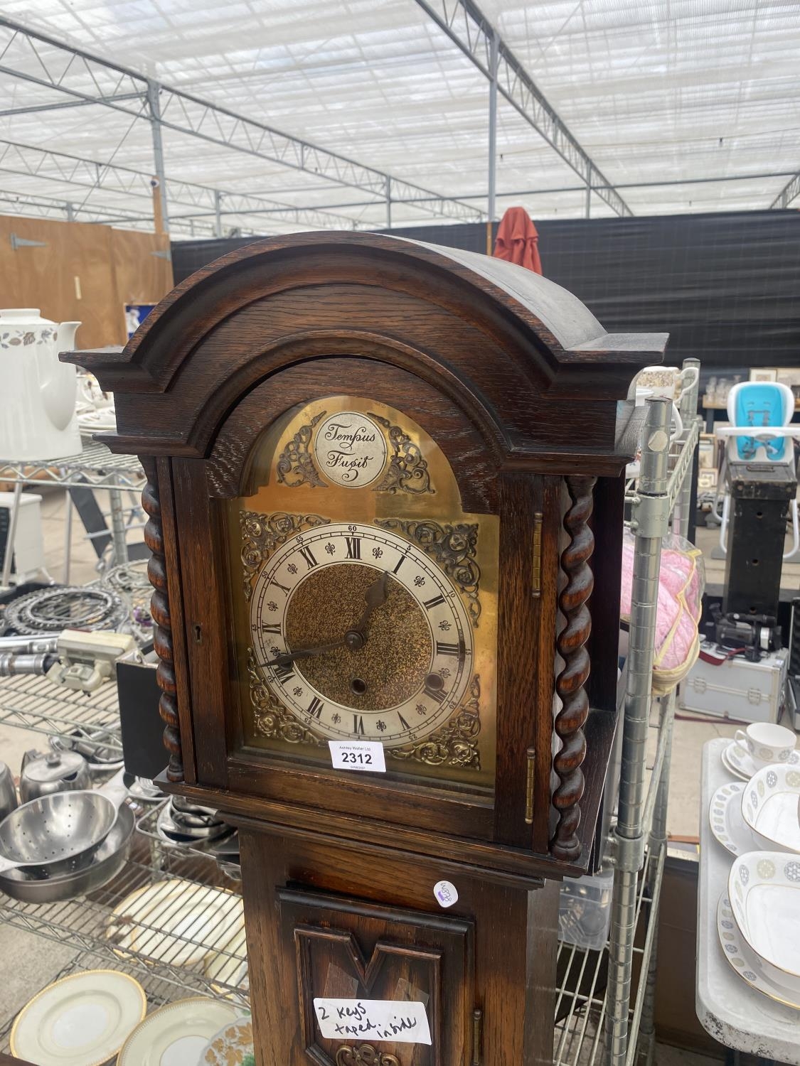 AN EARLY 20TH CENTURY OAK TEMPUS FUGIT GRANDMOTHER CLOCK WITH