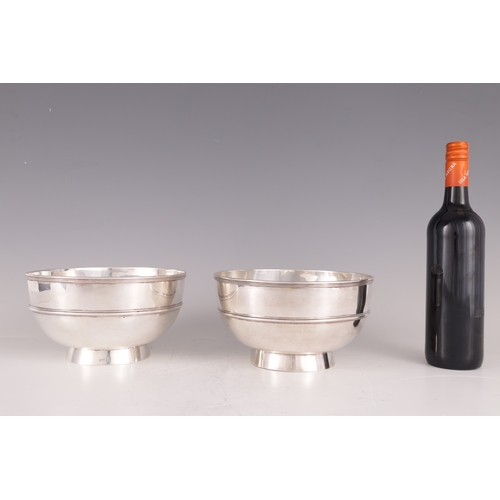59 - A LARGE PAIR OF LATE 19TH CENTURY CHINESE SILVER BOWLS OF MILITARY INTEREST having reeded rims and r... 