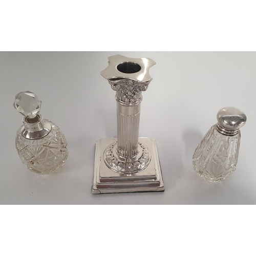 15 - A Sheffield weighted Silver columned Candlestick along with two Silver topped Sent Bottles.