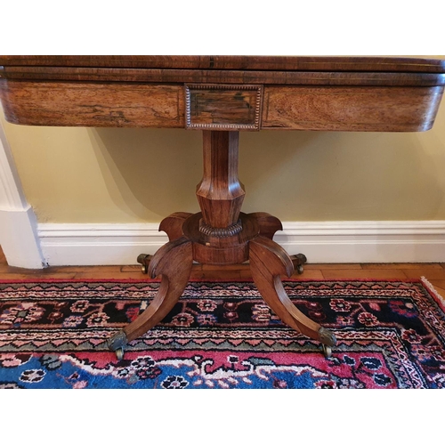 54 - A Magnificent Regency Rosewood and Brass inlaid Foldover Card table on a moulded platform base and w... 