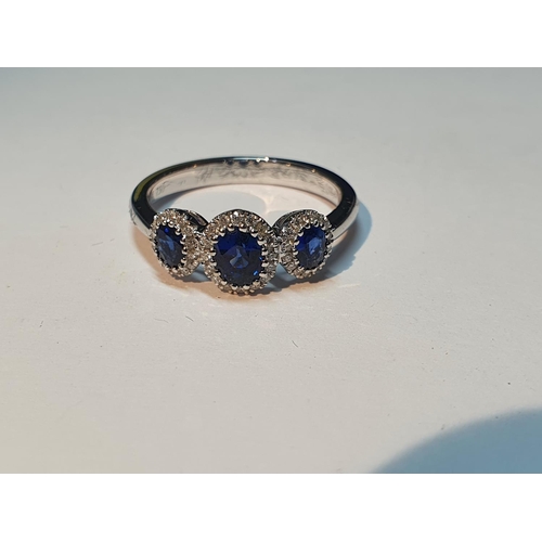12 - A sapphire and diamond dress ring. Total sapphire weight 0.84ct, stamped to mount. Total diamond wei... 