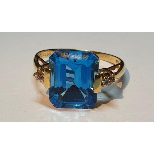 17 - A blue topaz and brilliant-cut diamond dress ring. Topaz weight 5cts, stamped to band. Stamped K18. ... 