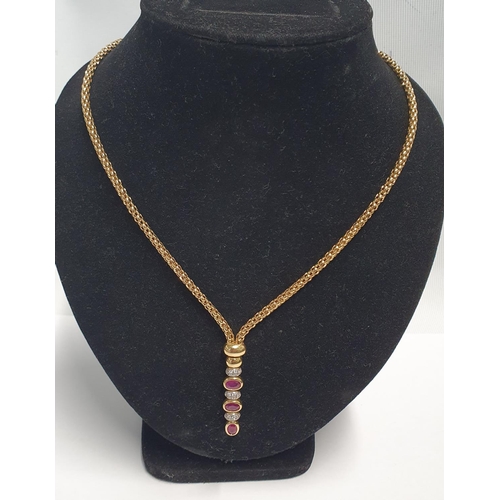 27 - An 18ct Gold, Ruby and Diamond Necklace, stamped 750. Total weight 25gms.