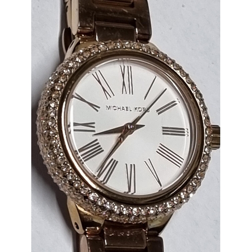 25c - A Ladies Michael Kors Watch. Seems to be keeping good time.