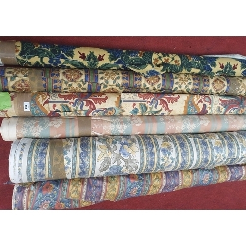 Six rolls of various bright patterned Fabrics.