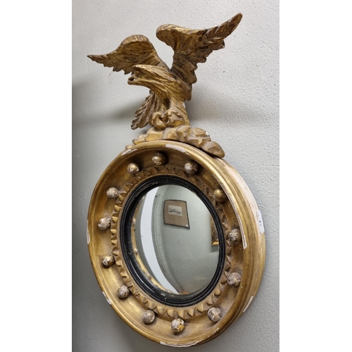 38 - A period 19th Century circular Mirror with eagle surmount of small size. 35 x 23 cm approx.