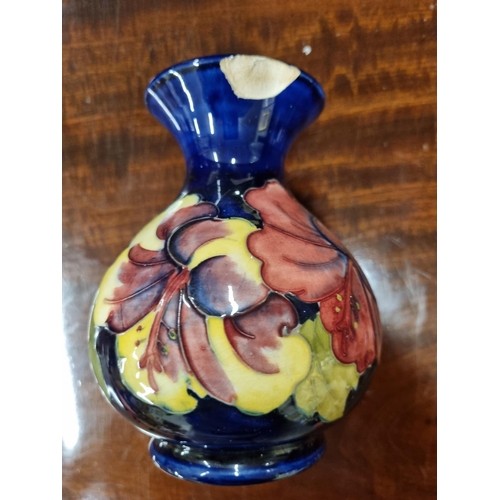 24 - Two Moorcroft Pottery Vases. (the Hibiscus vase has damage to rim). H 13,H 16 cm approx.
