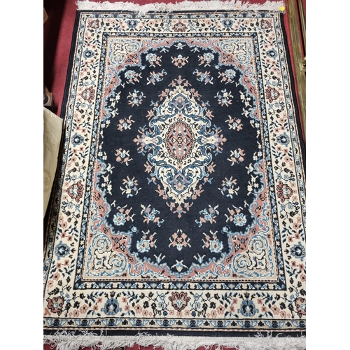 94 - A black and cream ground Rug with allover decoration. 170 x 120 cm approx.