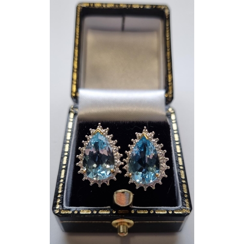 45 - A pair of White Gold and Diamond and Topaz Earrings.