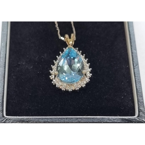 59 - A Gold, Diamond and Topaz Pendant with Chain.